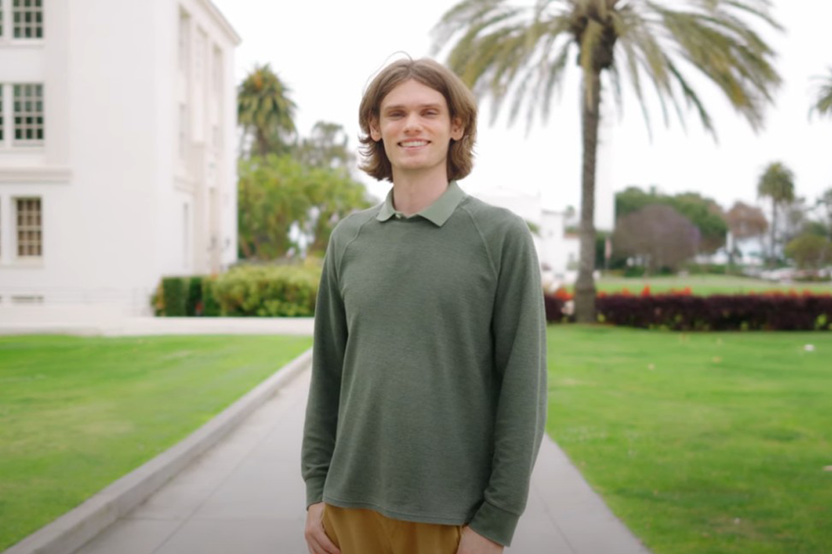A 3/4 shot of Alexander Moore standing in the middle of the Sunken Garden on the LMU campus.